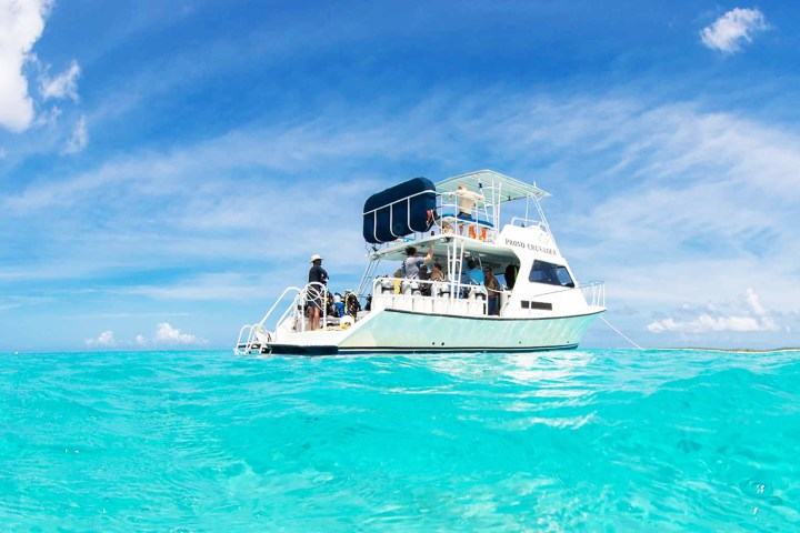 a blue and white boat floating on a body of water