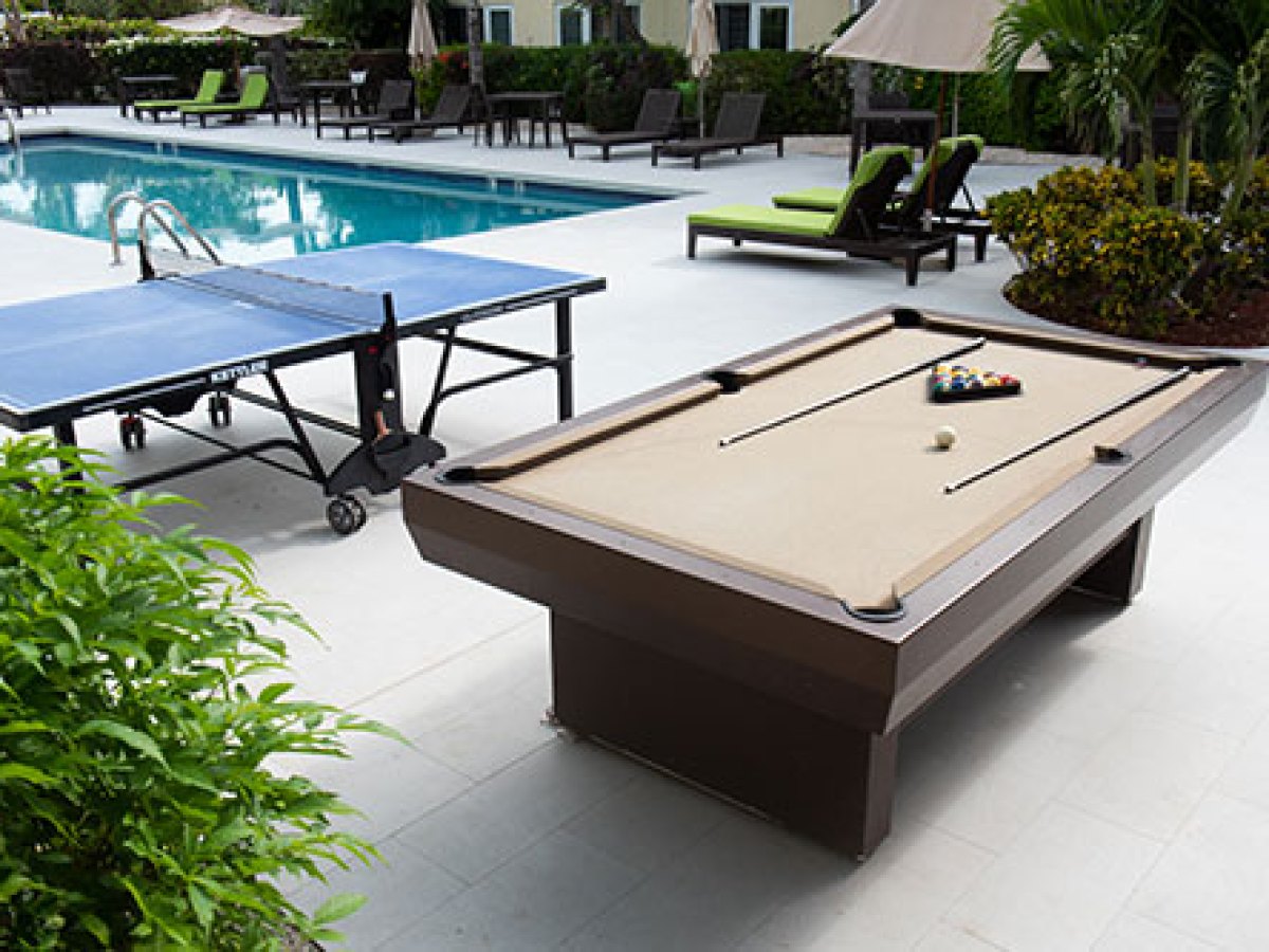 a group of people sitting at a table in a garden