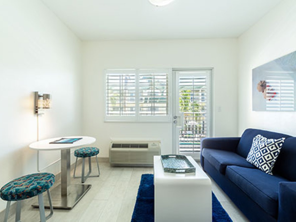 a living room filled with furniture and a large window