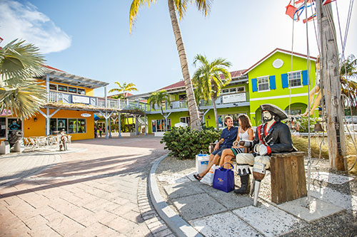 ports-of-call-shops-of-ports-of-call-2020-30 a group of people on a sidewalk next to a palm tree
