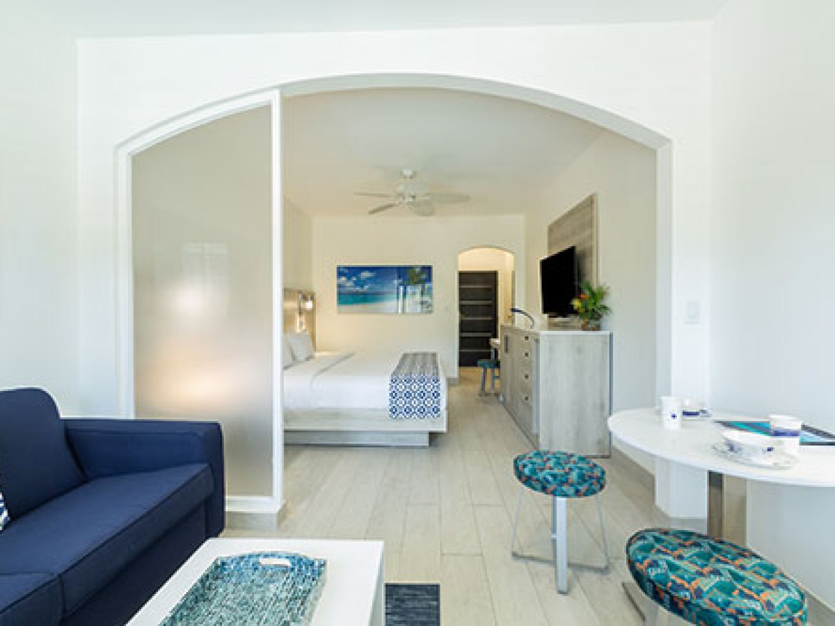 a living room filled with furniture and a large window